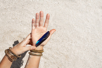 close up of woman hands with boho accessorories outdoors