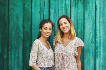 Beautiful girls in summer clothes pose in front of the countryside . The concept of summer fashion clothes.