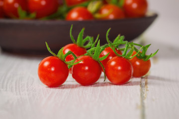 Fresh cherry tomato on white wood table. Close up lovely cherry tomato for background or wallpaper....
