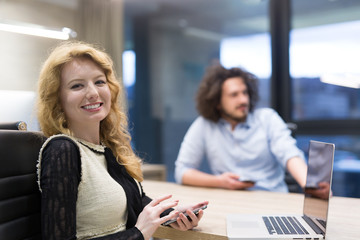 Elegant Woman Using Mobile Phone in startup office building