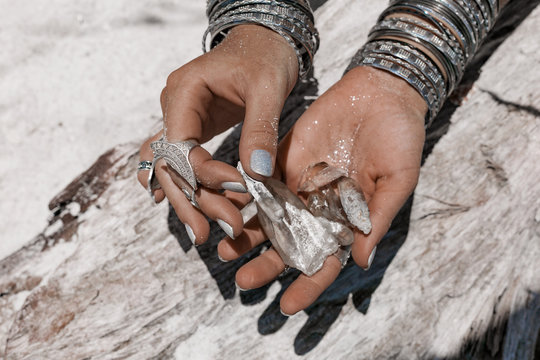 close up of woman hands holding magic stones