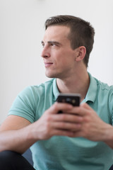 young man using a mobile phone  at home