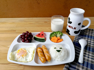 Fototapeta na wymiar Creative morning breakfast and milk for kids before go to school on wooden table with copy space. Kid meal concept. 