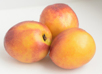 three peach on white background