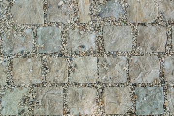 Light gray granite stone pavement texture, abstract cobblestone pavement close-up.