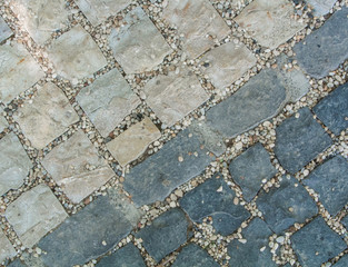 Obraz premium Dark and light gray granite stone pavement texture, abstract cobblestone pavement close-up.