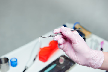 Dentist doctor hand holding medical tools in dental office. Concept of healthy