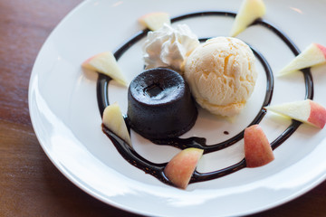 hot chocolate lava cake with vanilla ice cream ball, apple and whipped cream