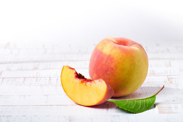 Peaches on white wood background