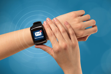 Hand with smartwatch and blue background