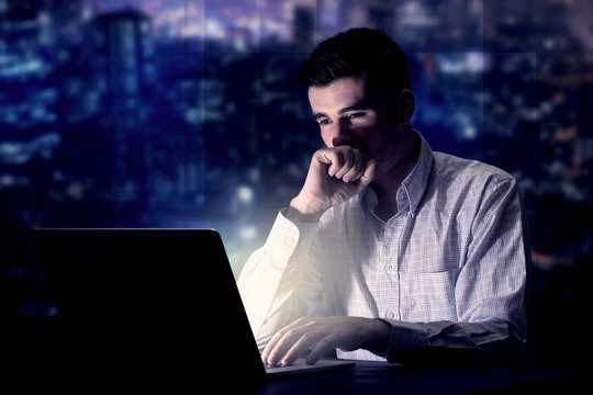 Businessman in the office at night