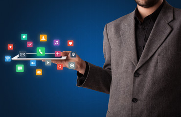 Businessman holding tablet with multimedia concept