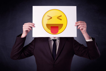 Businessman holding paper with emoticon