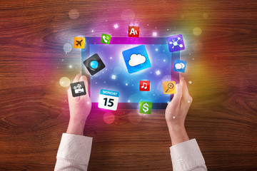 hands holding tablet