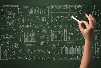 A business person drawing data on chalkboard