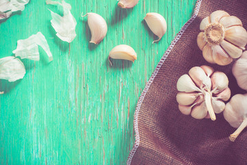 Fresh garlic on rustic wood and bokeh background