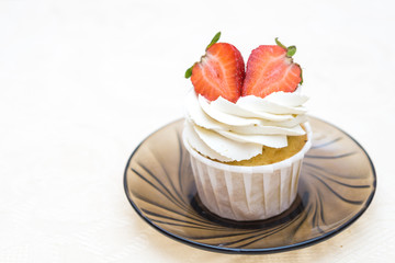 cake with cream and strawberries on a glass plate