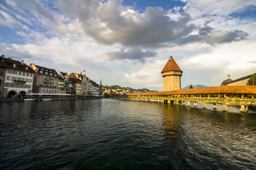 TOP OFF ATTRACTION IN SWITZERLAND. LUCERNE OLD WOOD CHAPEL BRIDGE IN SUMMER SUNSET LIGHT