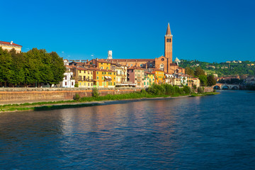 VERONA, ITALY. September 08, 2016: Morning scenery with Adige River, Bell tower of Santa Anastasia's church and the embankment of Adige River.