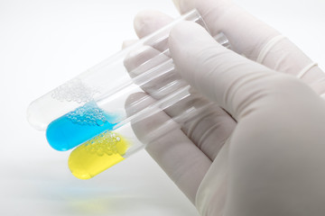 Hand holding blood in test tube, selective color technique