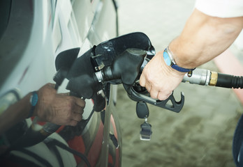 man hand filling car with petrol pump