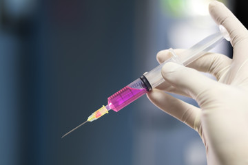 Syringe, medical injection Liquid narcotic in hand, palm or fingers. Medicine plastic vaccination vintage color.