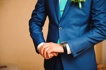 elegant businessman dressed clock before meeting with partners