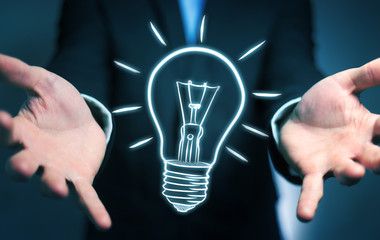 Businessman holding a sketch lightbulb