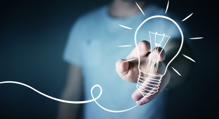 Businessman touching a sketch lightbulb