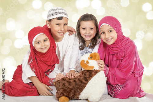 "Happy little Muslim kids playing with sheep toy 