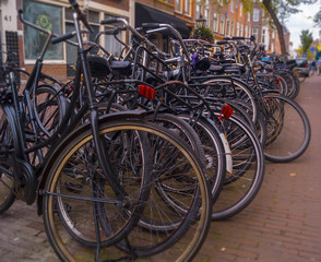 Obraz na płótnie Canvas a row of different bikes lined up on the street in The Netherlands