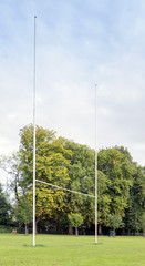 Obraz premium Rugby posts against trees and sky