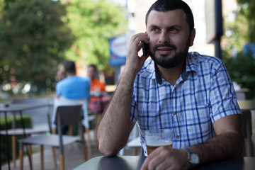 Handsome man using mobile phone in cafe