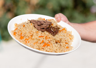 Pilaf in a plate in a cafe