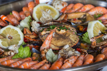 serving plate seafood and crab in big metal dish