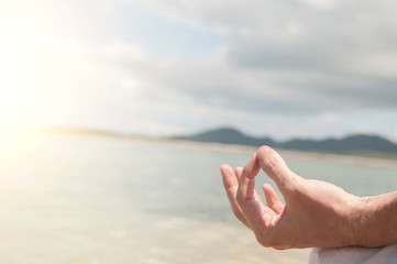 Man meditating on the  tropical shore