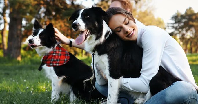 Beautiful couple walking dogs and bonding in nature