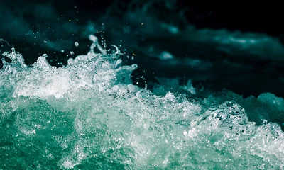Papier Peint photo Eau Splash of stormy water in the ocean on a black background