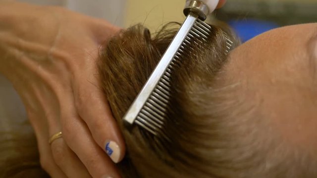 therapeutic prophylactic procedures for hair with A metal comb