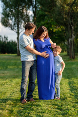 Fototapeta premium Happy pregnant family of three expecting new baby