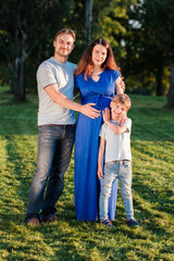 Fototapeta premium Happy pregnant family of three expecting new baby