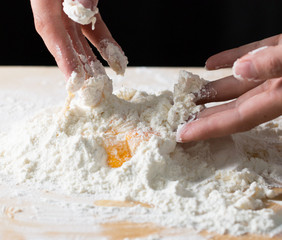 The hand kneads the dough