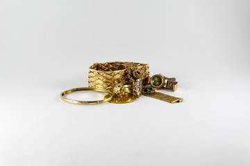 luxurious and expensive golden bracletes, rings and coin. Luxury Jewellery