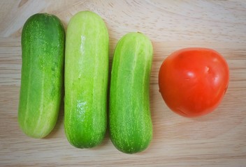 Fresh Tomato with Cucumbers on Cutting Board