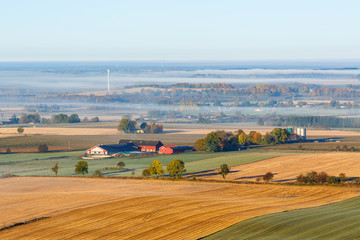 Countryside view with a farm in the field
