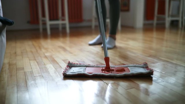 Woman using mop cleaner to do household chores faster