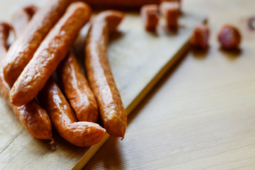 Smoked sausages on wooden board