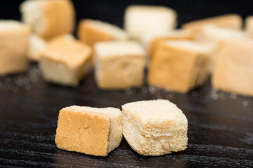 close up of crouton on black background, the crispy bread in cubic shape for ingredient or side dish