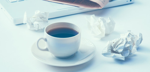 Working with crumpled paper and coffee cup on table background