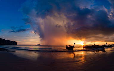 Long tail boat at Sunset on the beach of Ao Nang in Krabi